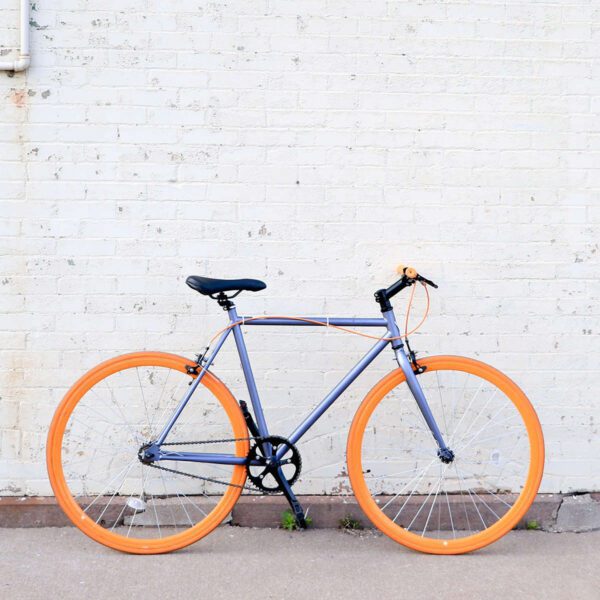 A bicycle parked on the side of a building.