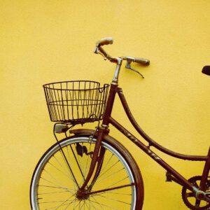 A bicycle with basket on the front of it.