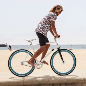 A man riding on the back of a bicycle.